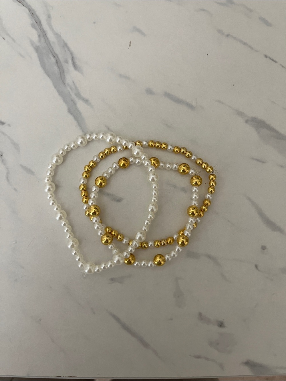3 pack of gold and white bracelets
